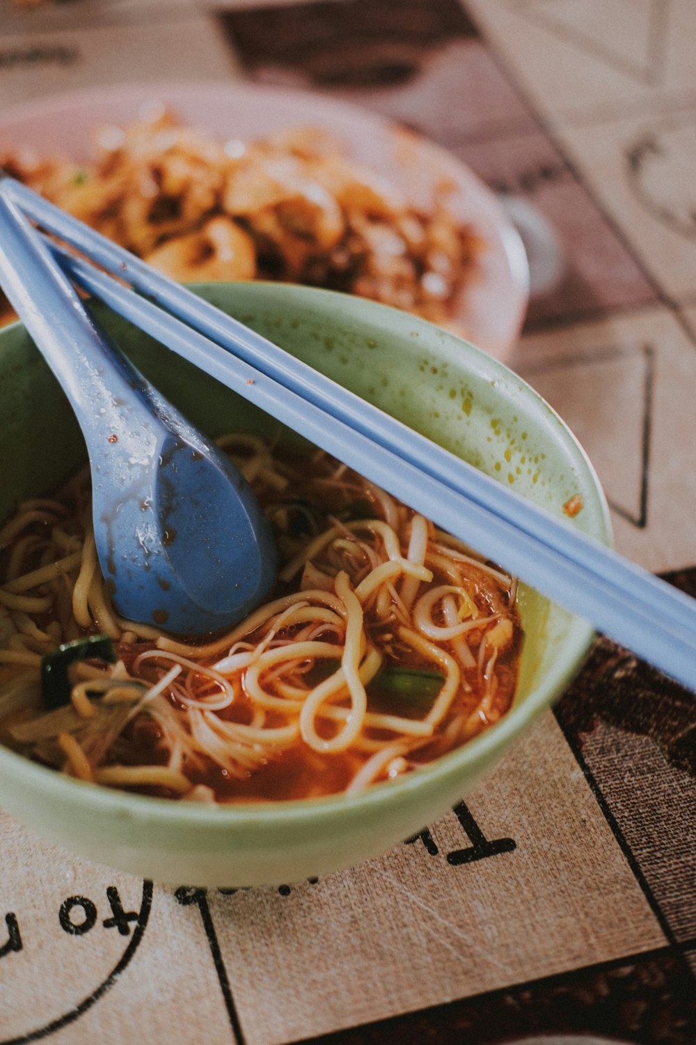 white chopsticks on white and blue ceramic bowl