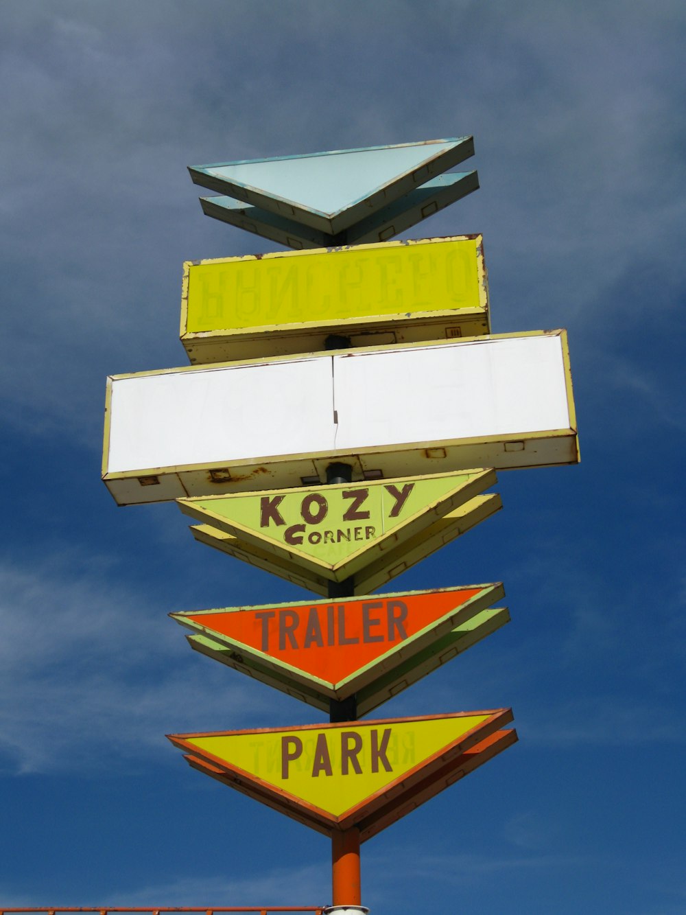 white and yellow street sign