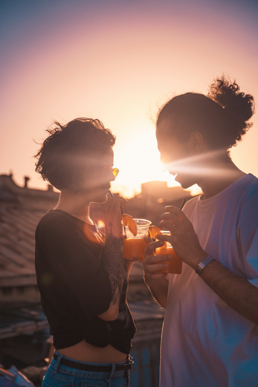 man and woman holding hands during sunset