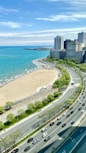 cars on road near high rise buildings during daytime