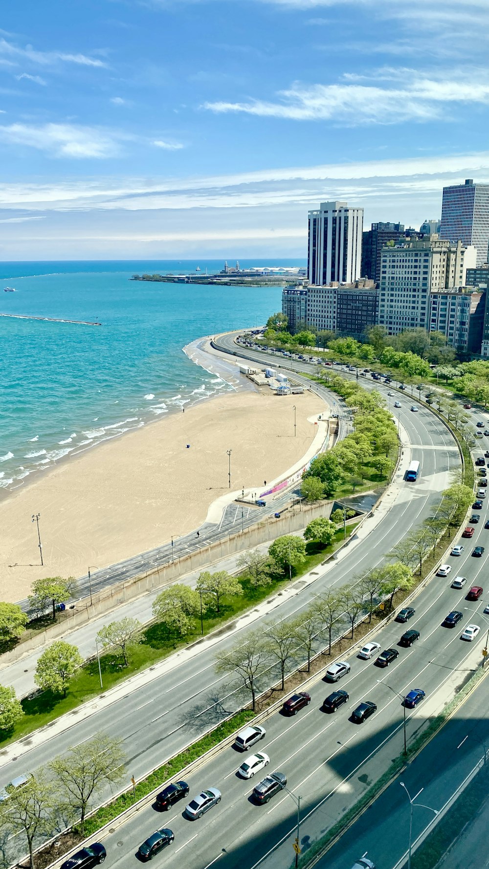 cars on road near high rise buildings during daytime