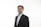 a man in a suit and tie posing for a picture