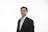 a man in a suit and tie posing for a picture