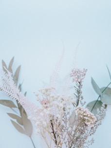 A beautifully framed pressed floral arrangement from a wedding bouquet with soft pastel tones.
