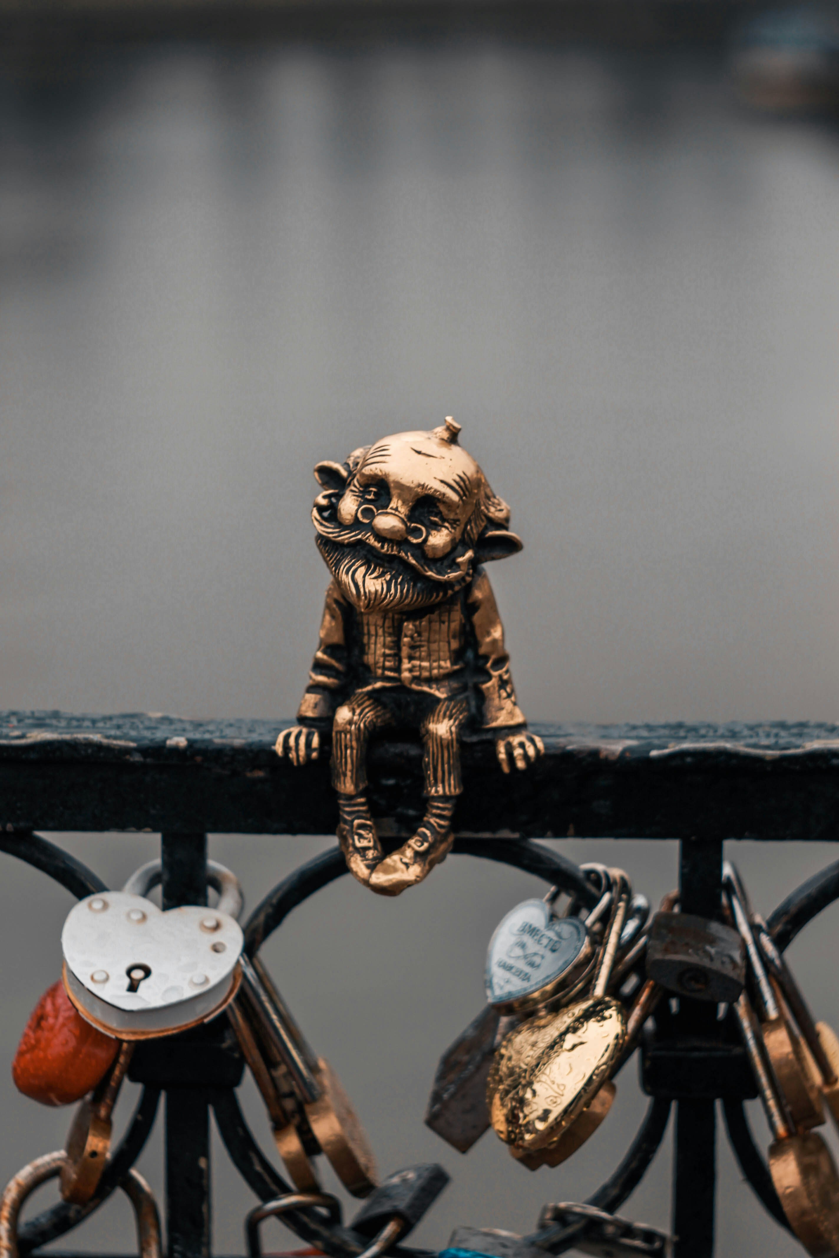 black and gold skeleton figurine on black metal fence