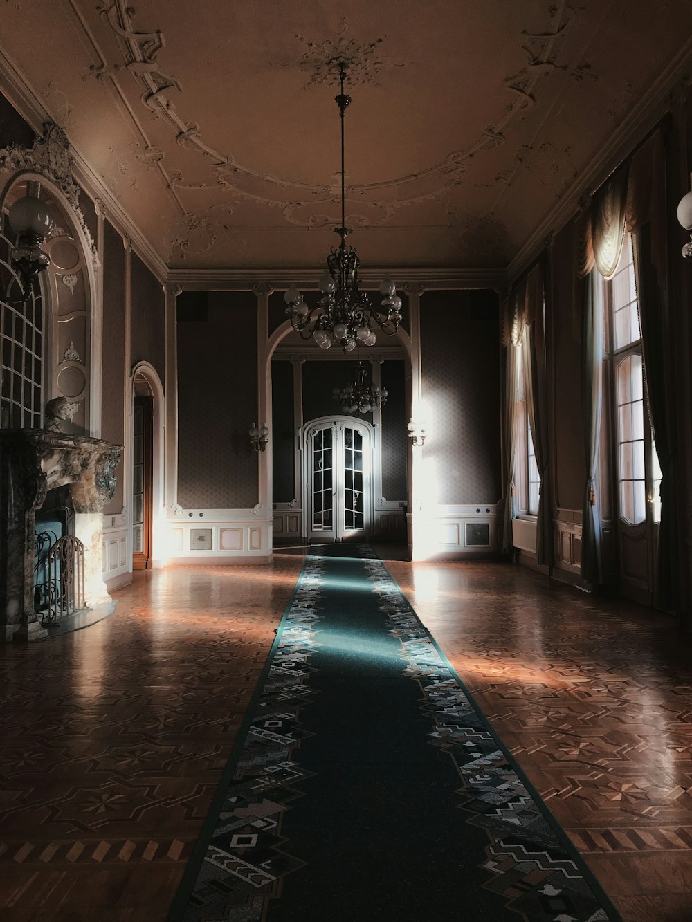 white and brown hallway with green carpet