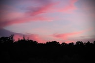 A fine art reproduction of a serene landscape bathed in twilight colors, blending blues and yellows softly.