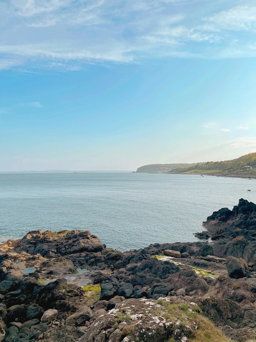 brown rocky shore under blue sky during daytime