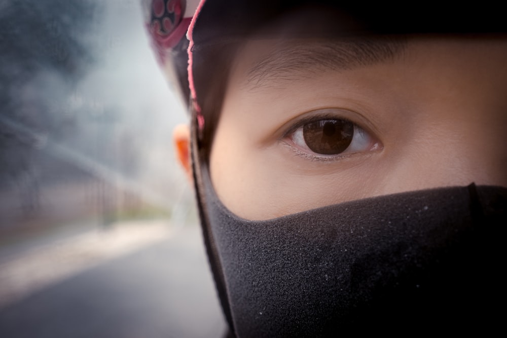 person wearing black and red face mask