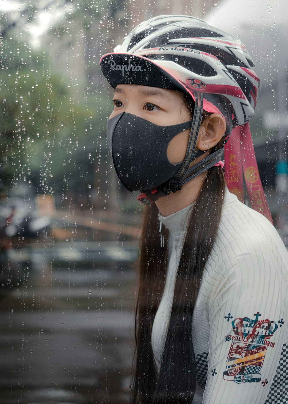 woman in white knit sweater wearing black mask