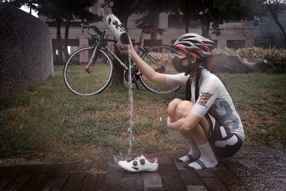 person in white and black nike sneakers riding on bicycle