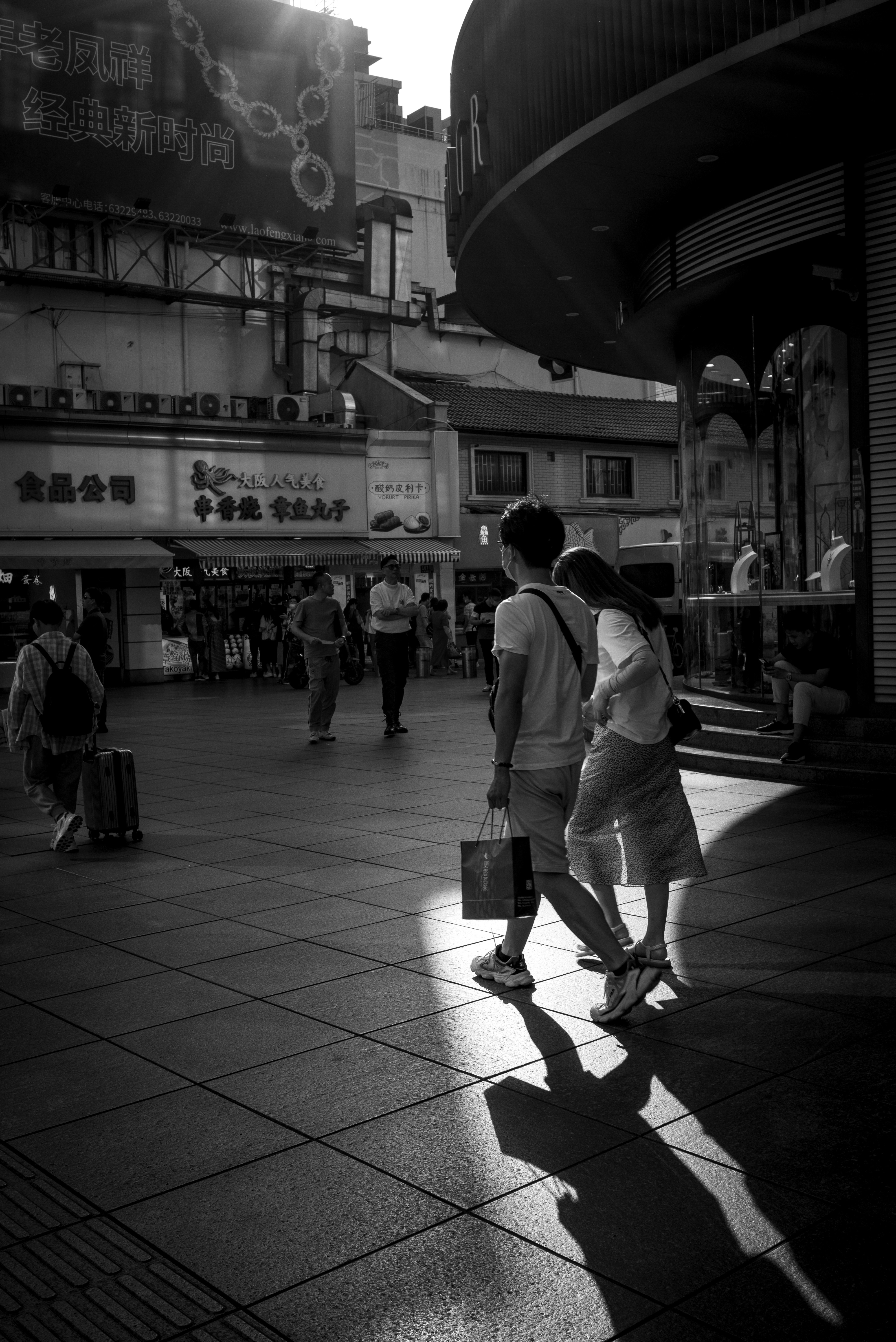 grayscale photo of people walking on sidewalk