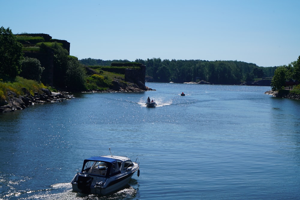 black suv on water near green trees during daytime