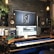 A music production studio setup featuring two large speakers, two computer monitors displaying audio software, a keyboard with illuminated keys, and various audio equipment. The room has a dark brick wall, potted plants, and hanging industrial-style light fixtures providing a cozy atmosphere.