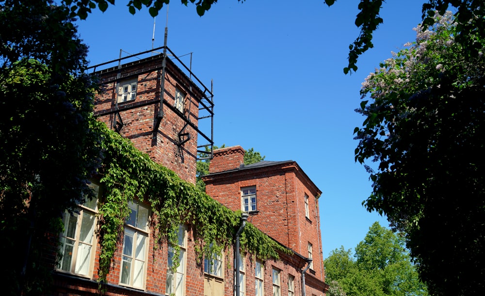 brown brick building near green trees during daytime