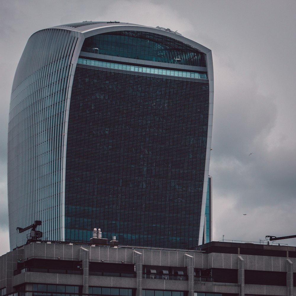 black and gray building under white clouds and blue sky during daytime