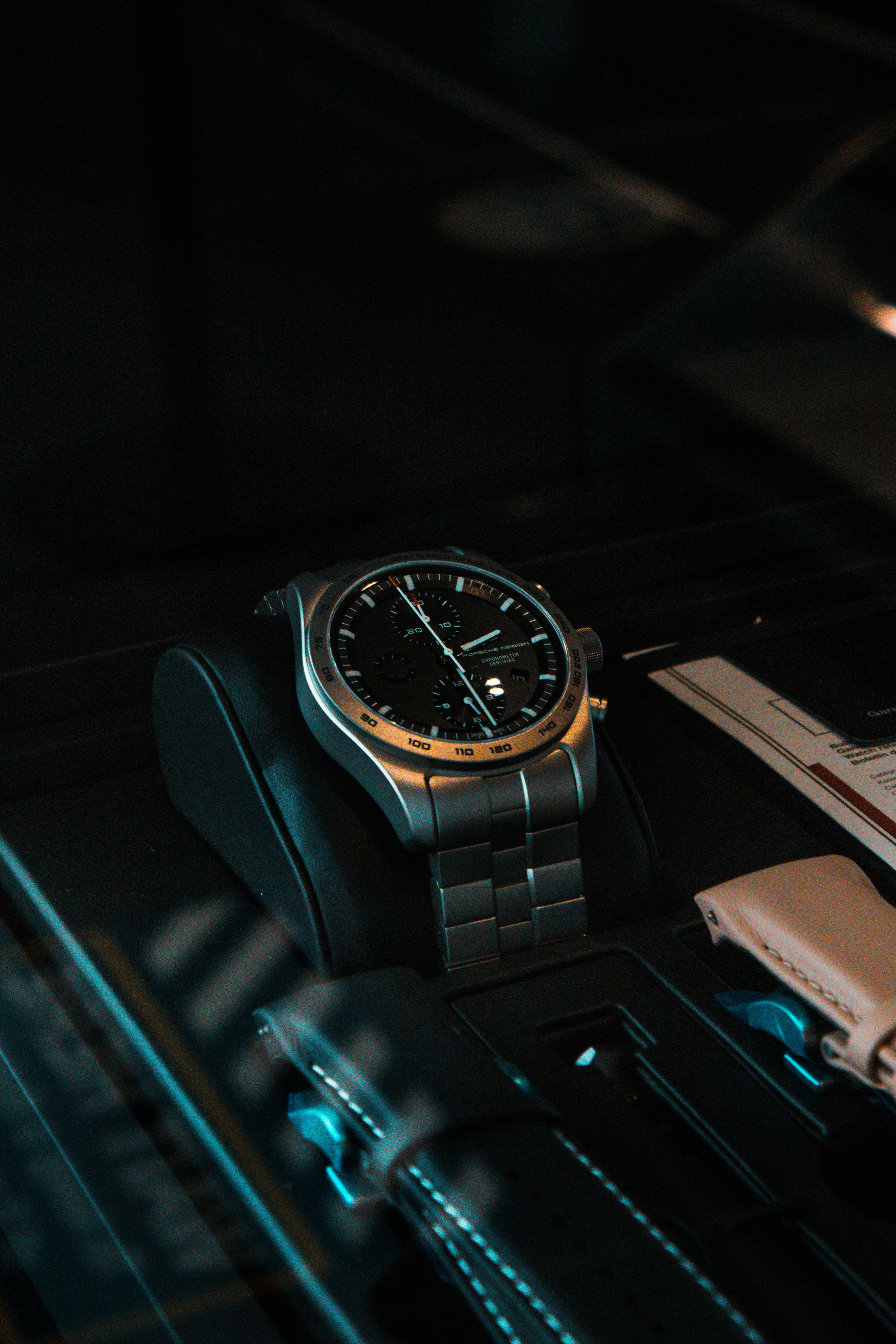 a watch sitting on top of a black table