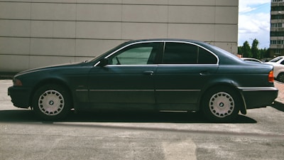 Side view of a sedan with anti-scratch body protection installed, parked outdoors.
