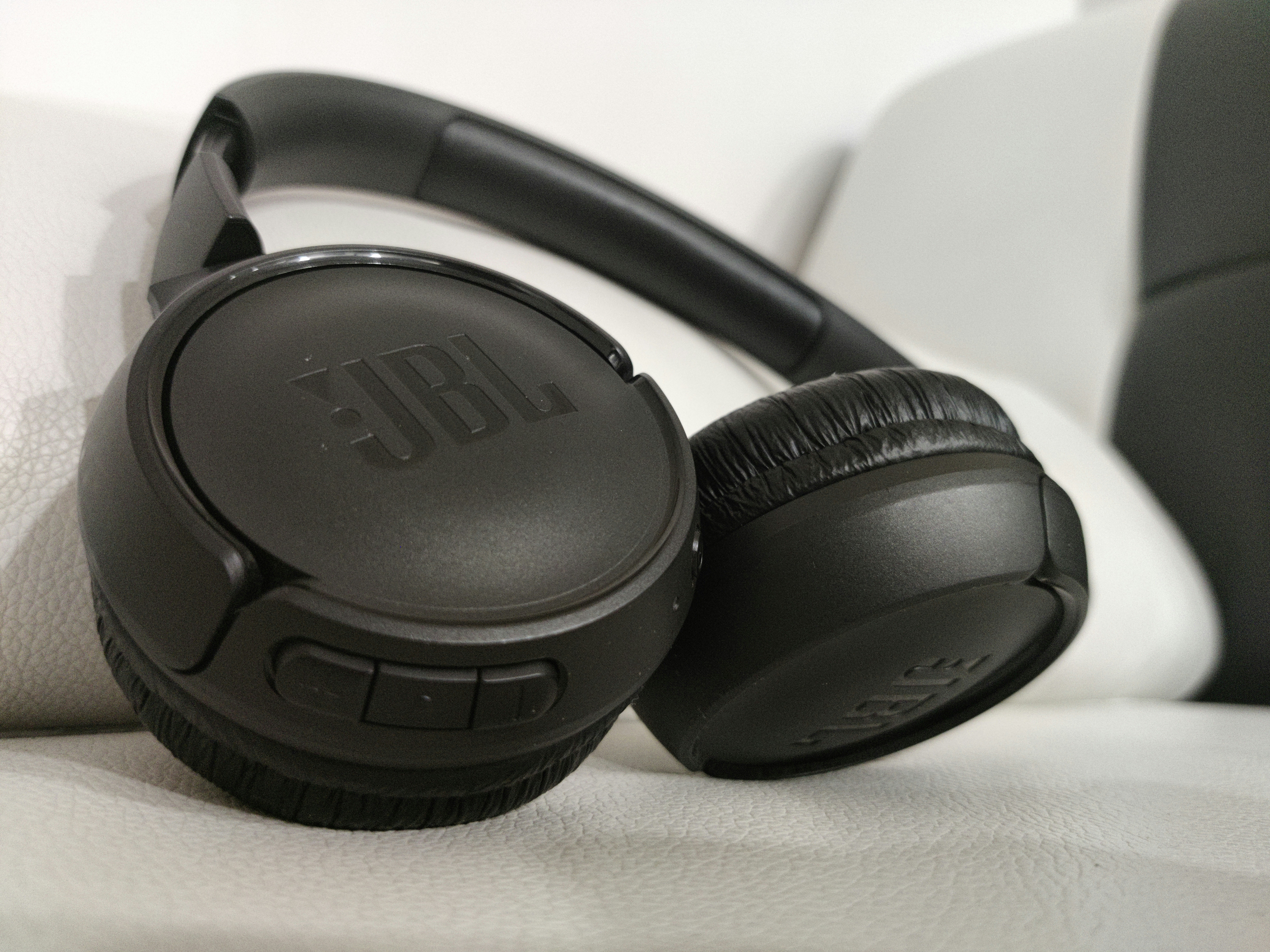 Premium headphones on dark surface with soft ambient lighting