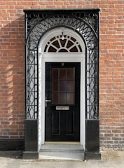 brown wooden door on brown brick wall