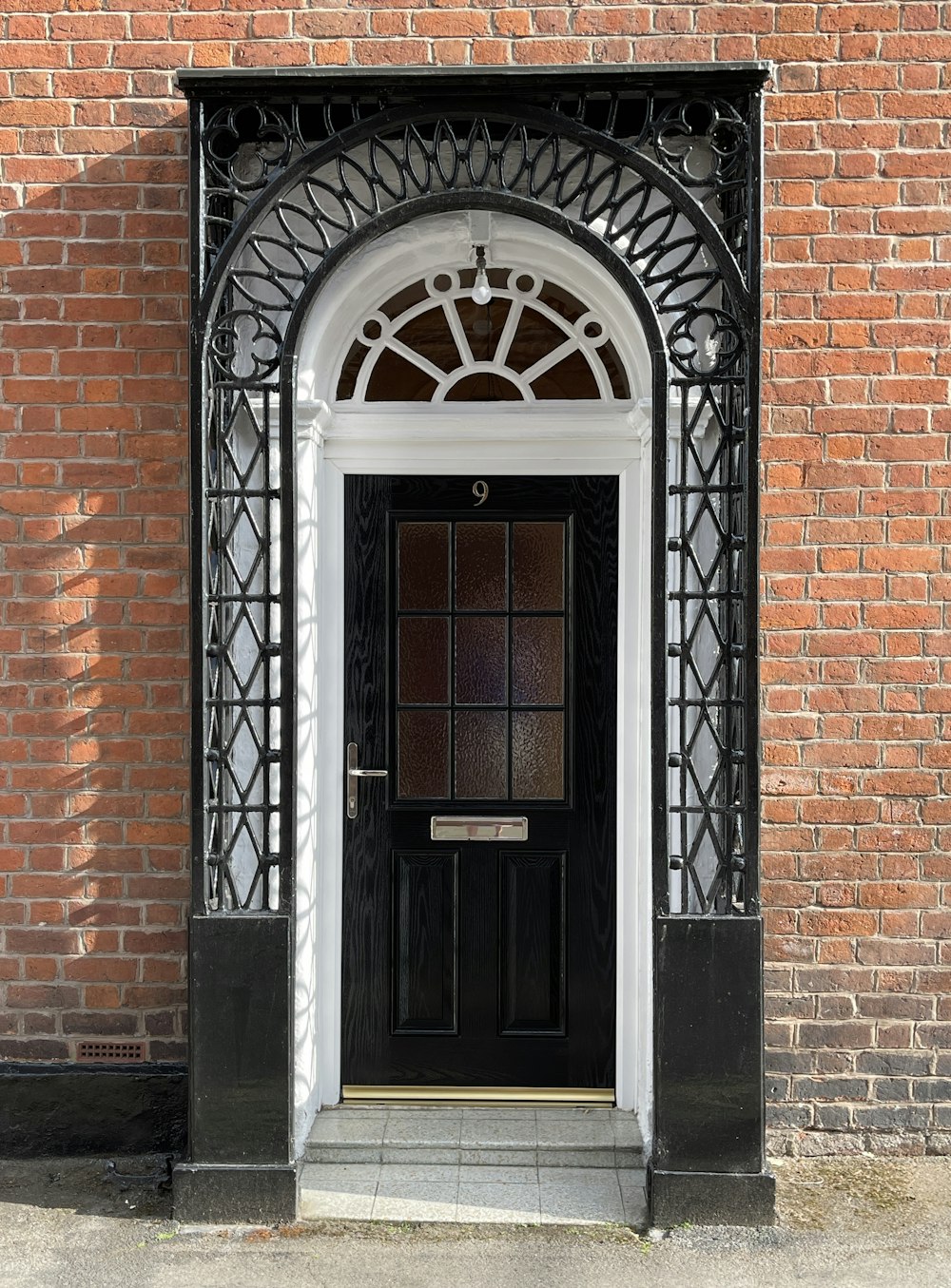 brown wooden door on brown brick wall