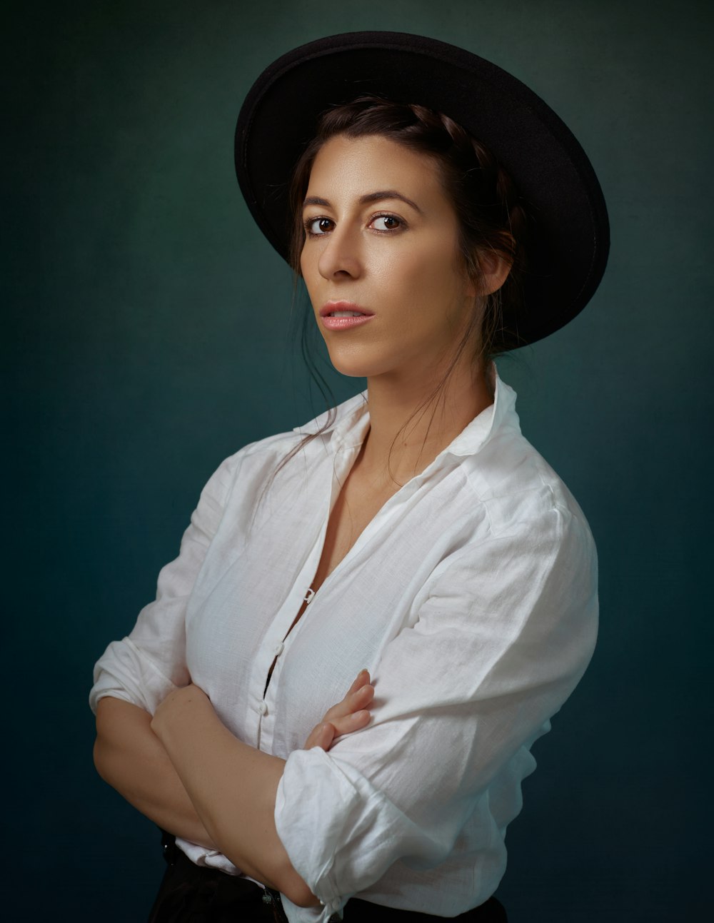 woman in white dress shirt and black fedora hat