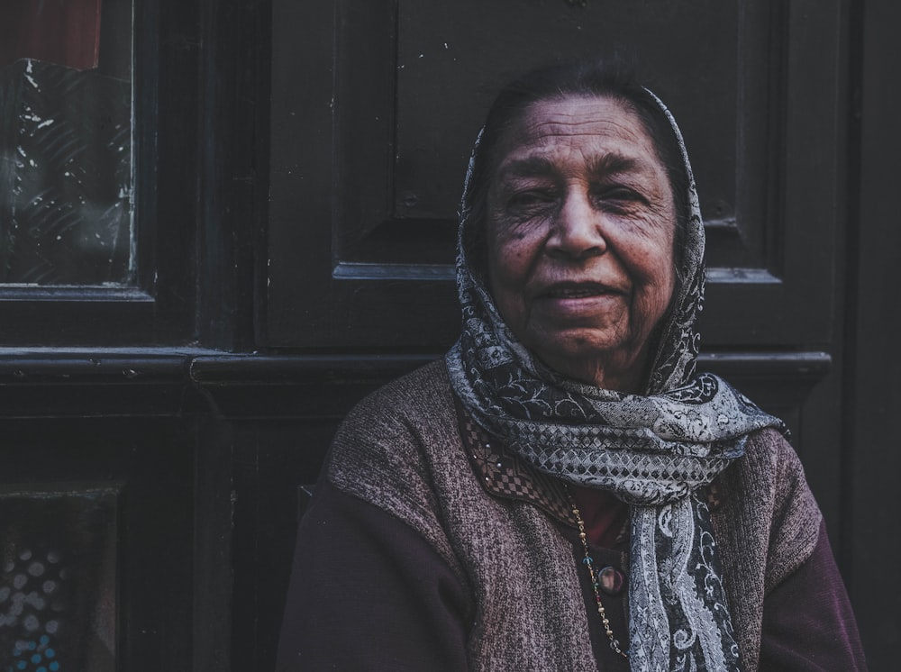 woman in gray and black scarf