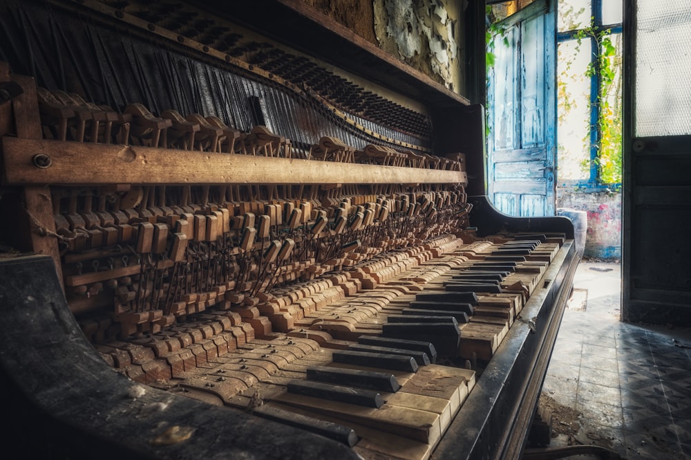 brown wooden piano near blue wooden door