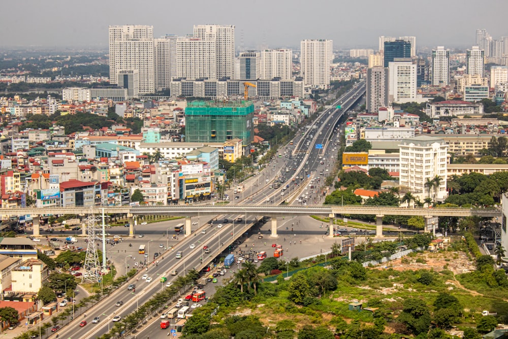 cars on road near city buildings during daytime