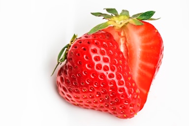 macro photography,how to photograph strawberry in a heart shape; red strawberry on white surface