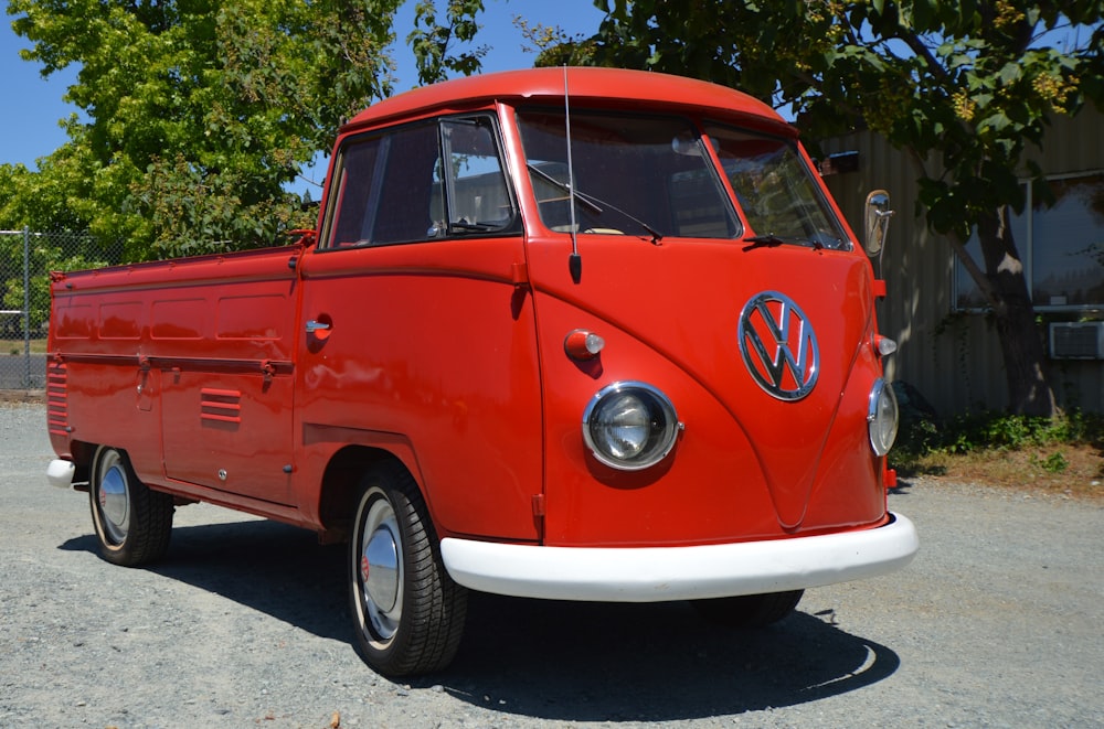 red and white volkswagen t-2 van parked on gray concrete road during daytime