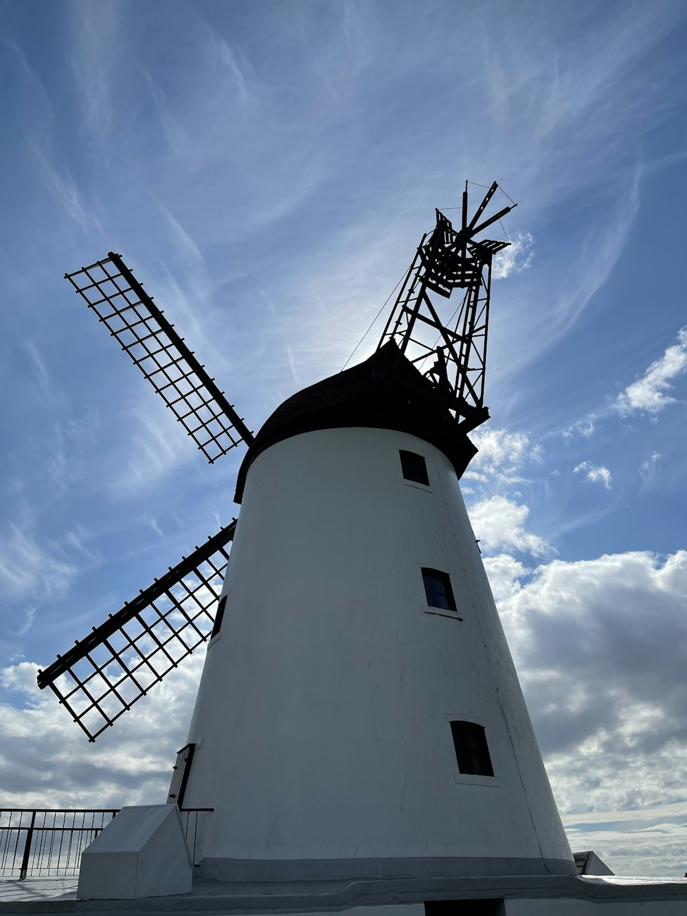 white and black lighthouse under blue sky