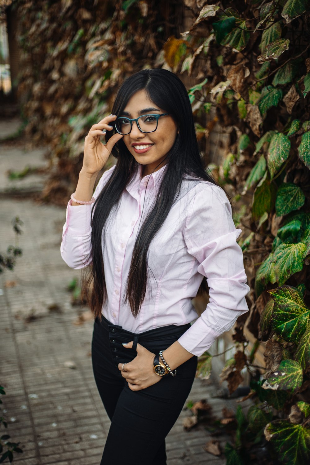 woman in white dress shirt and black skirt wearing black framed eyeglasses