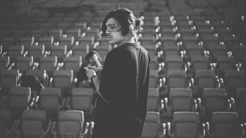 woman in black long sleeve shirt standing on stadium