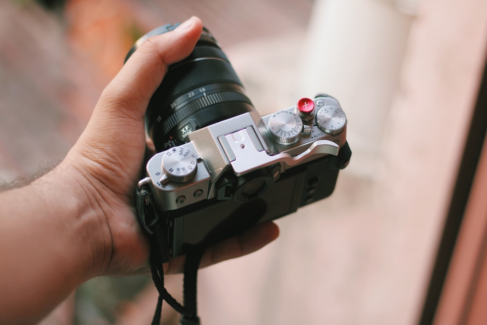 person holding black dslr camera