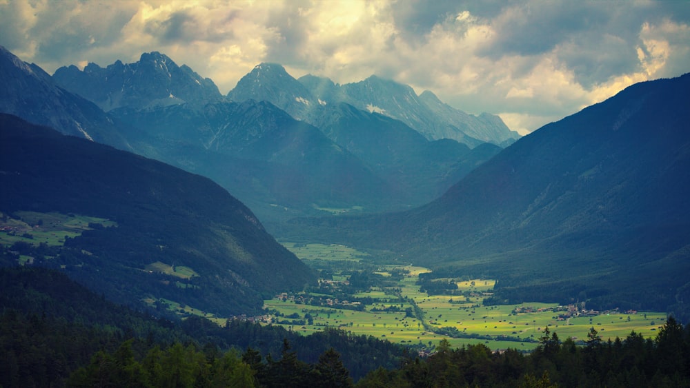 green mountains under white clouds during daytime