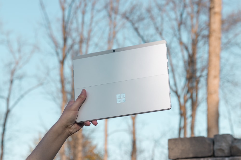 person holding white cardboard box