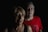 man in red crew neck shirt beside man in black tank top