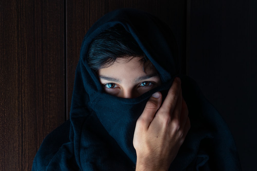 woman covering her face with blue hijab