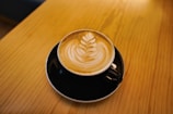 Close-up of a special coffee cup with latte art on a wooden table
