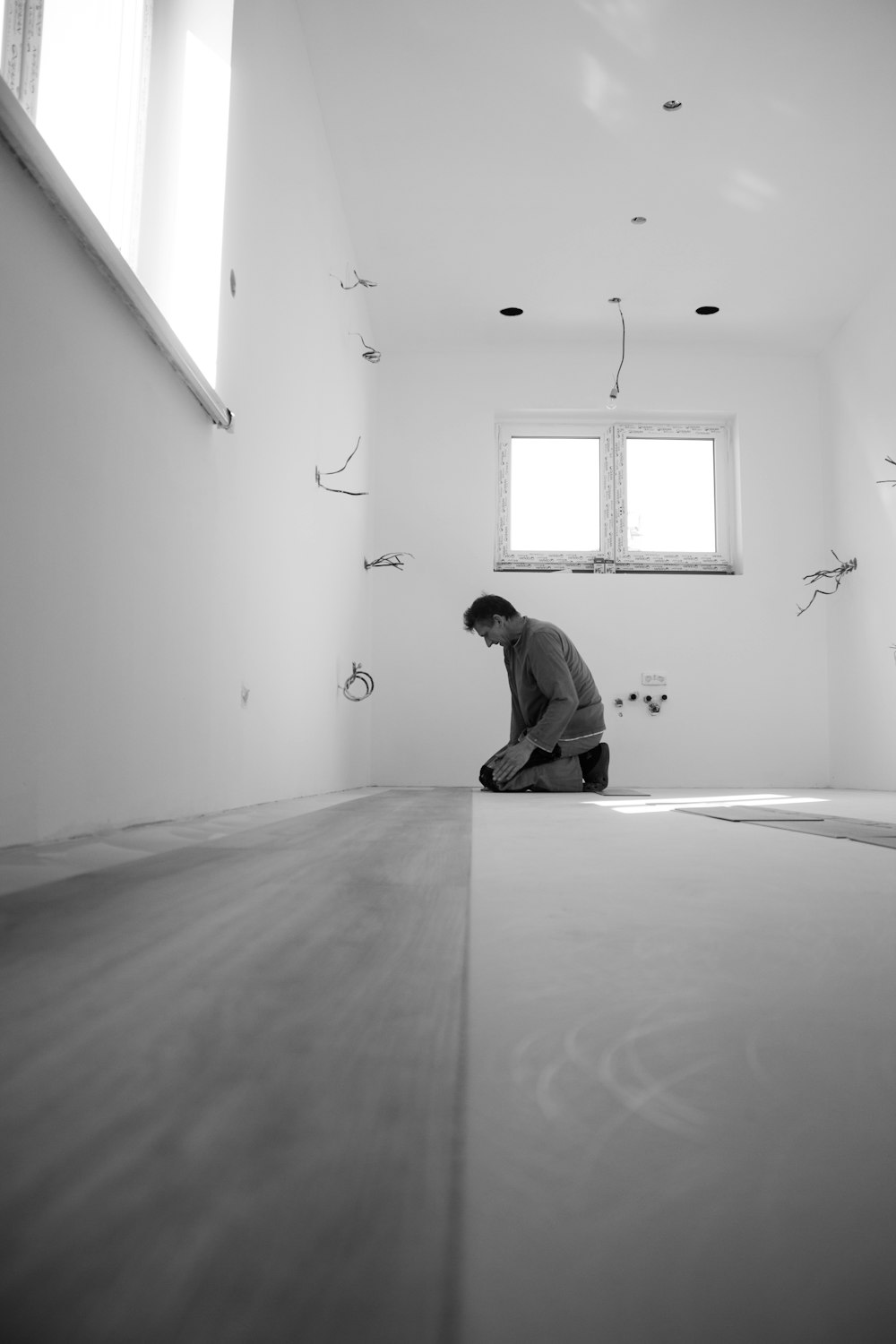 man in black jacket sitting on floor