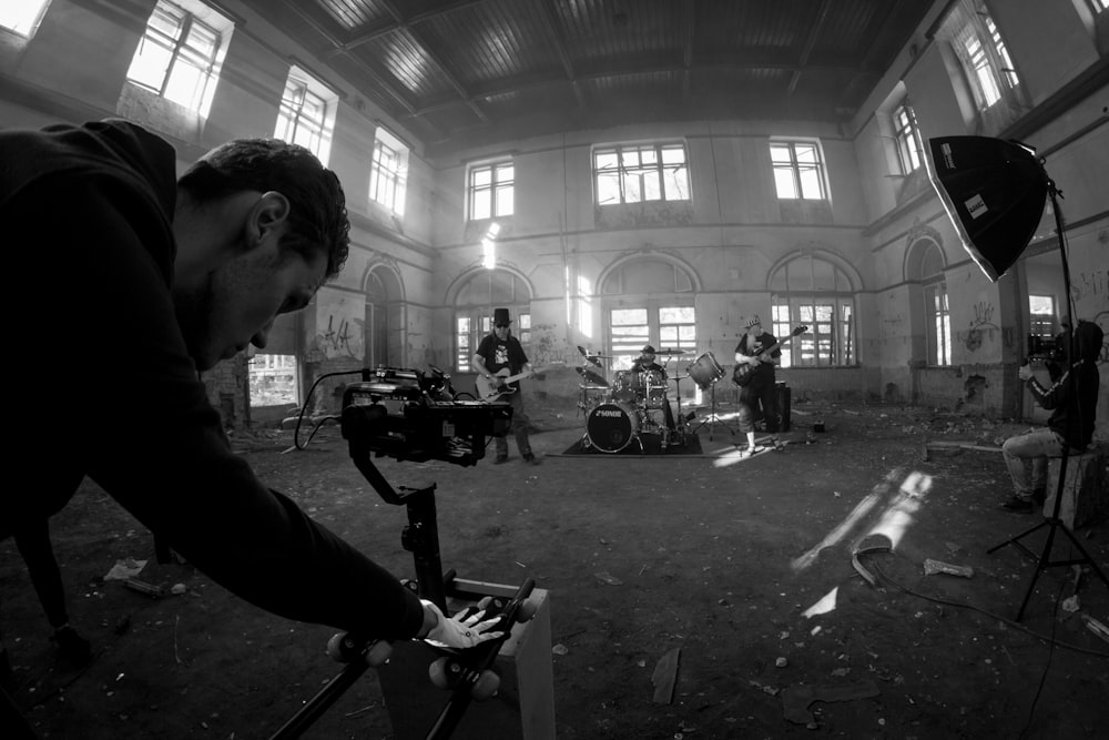 grayscale photo of man playing electric guitar