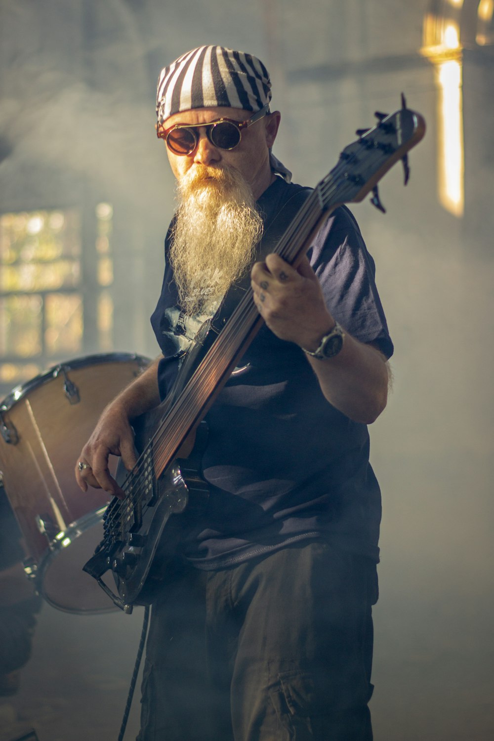 man in black button up shirt playing brown acoustic guitar