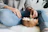 A smiling woman enjoying a handful of crunchy makhana in a cozy kitchen setting.