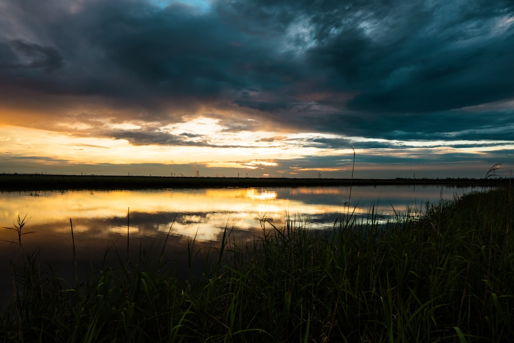 the sun is setting over a body of water