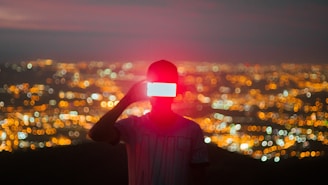man in red knit cap and black shirt standing on building during night time