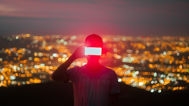 man in red knit cap and black shirt standing on building during night time