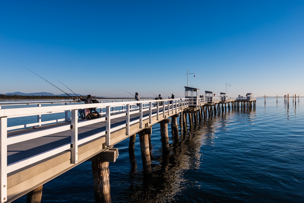 Ponte di legno bianco sul mare blu sotto cielo blu durante il giorno