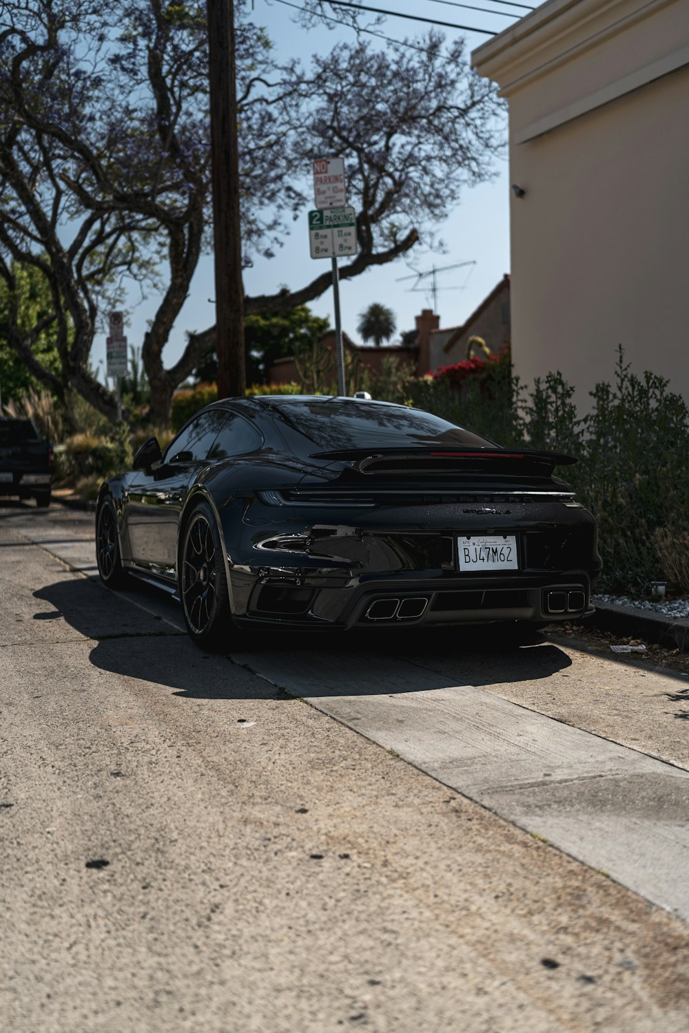 black bmw m 3 parked on sidewalk during daytime