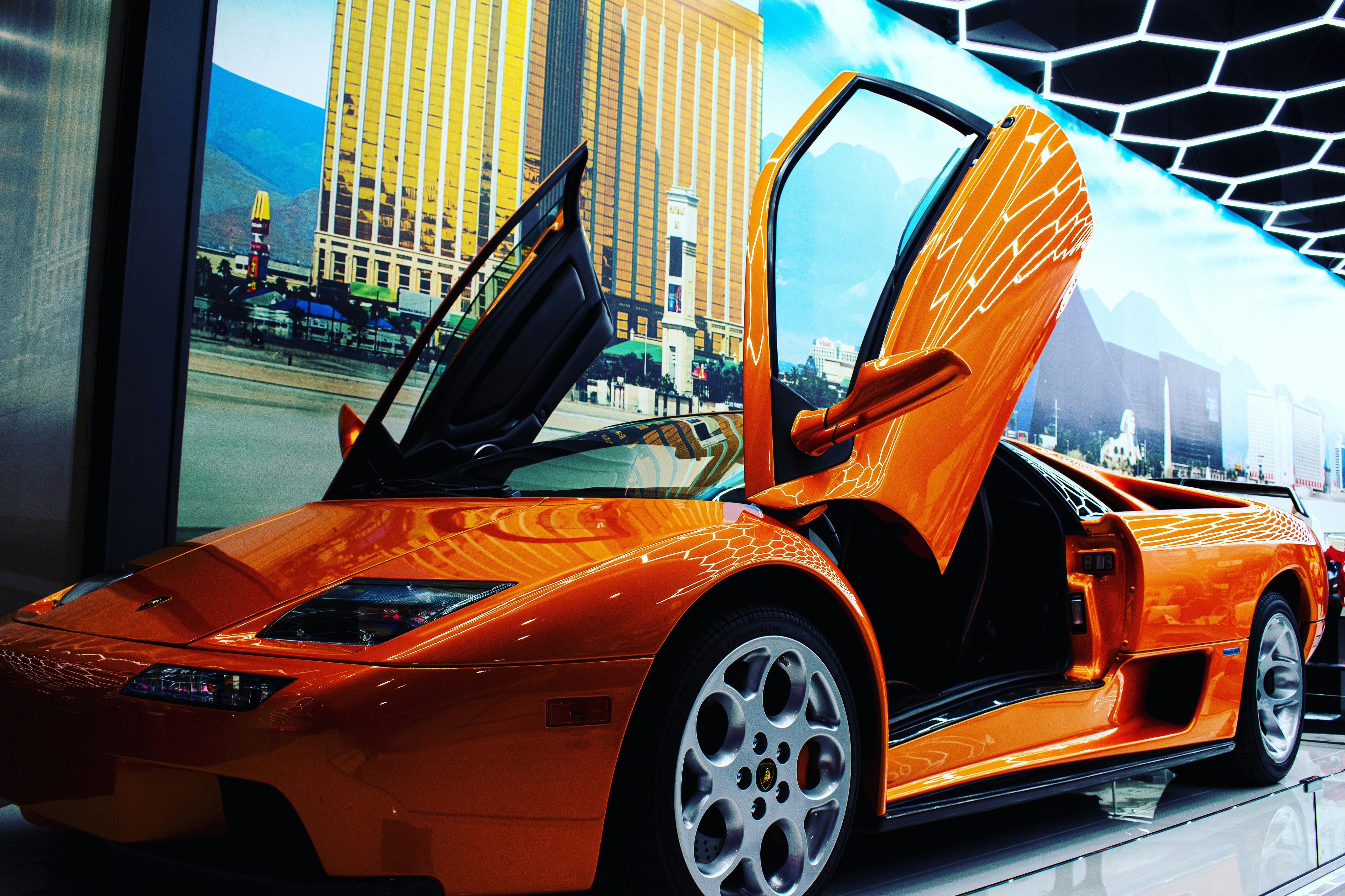 Orange ferrari 458 italia parked on parking lot during daytime